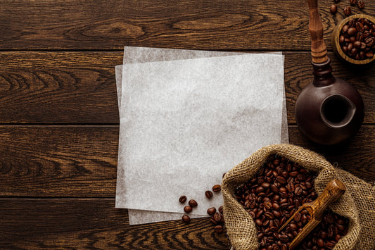 a wooden table topped with two bags of coffee beans