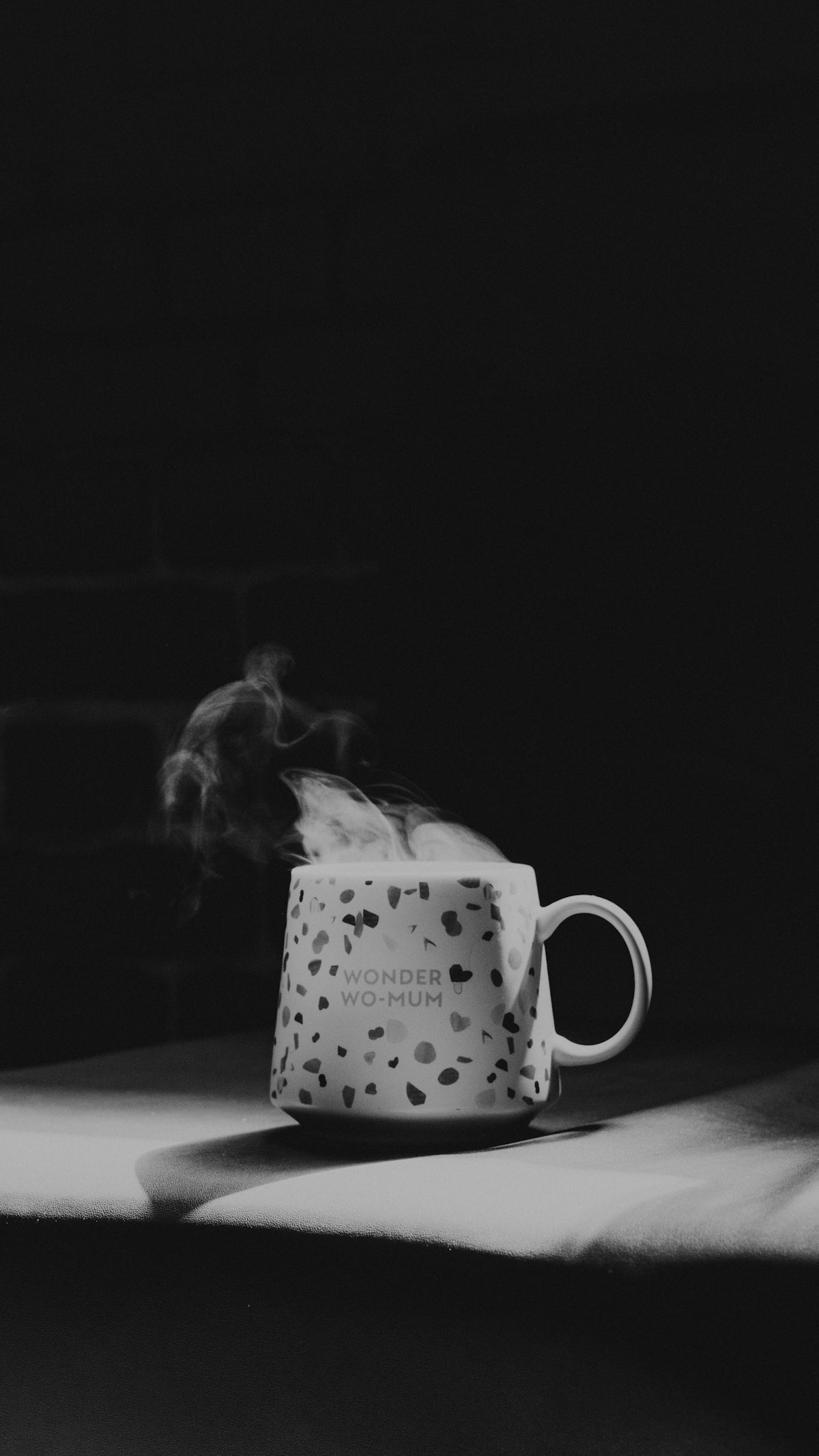 grayscale photo of woman in white shirt sitting on chair