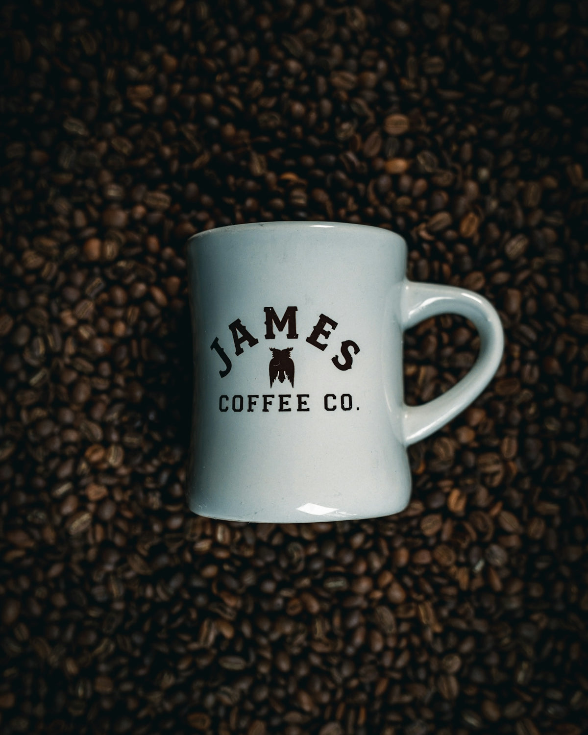 a white mug with a black label on a brown surface