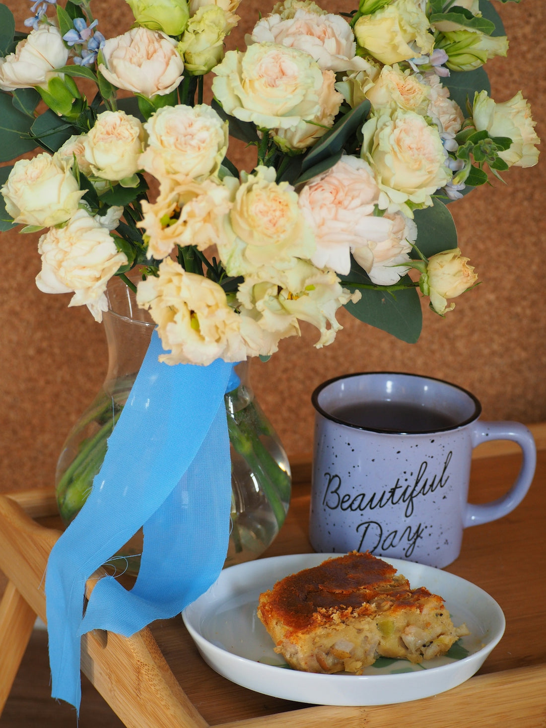 a vase of flowers next to a cup of coffee