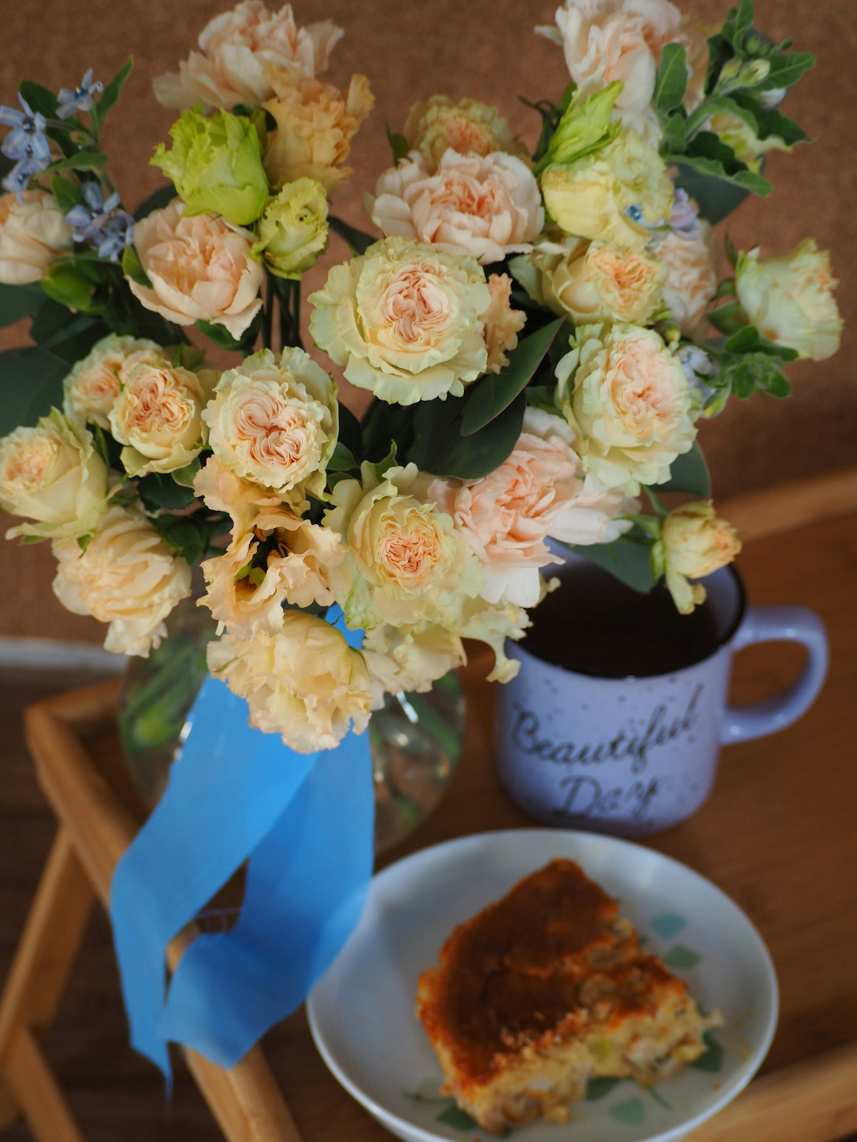 a vase of flowers next to a plate of food