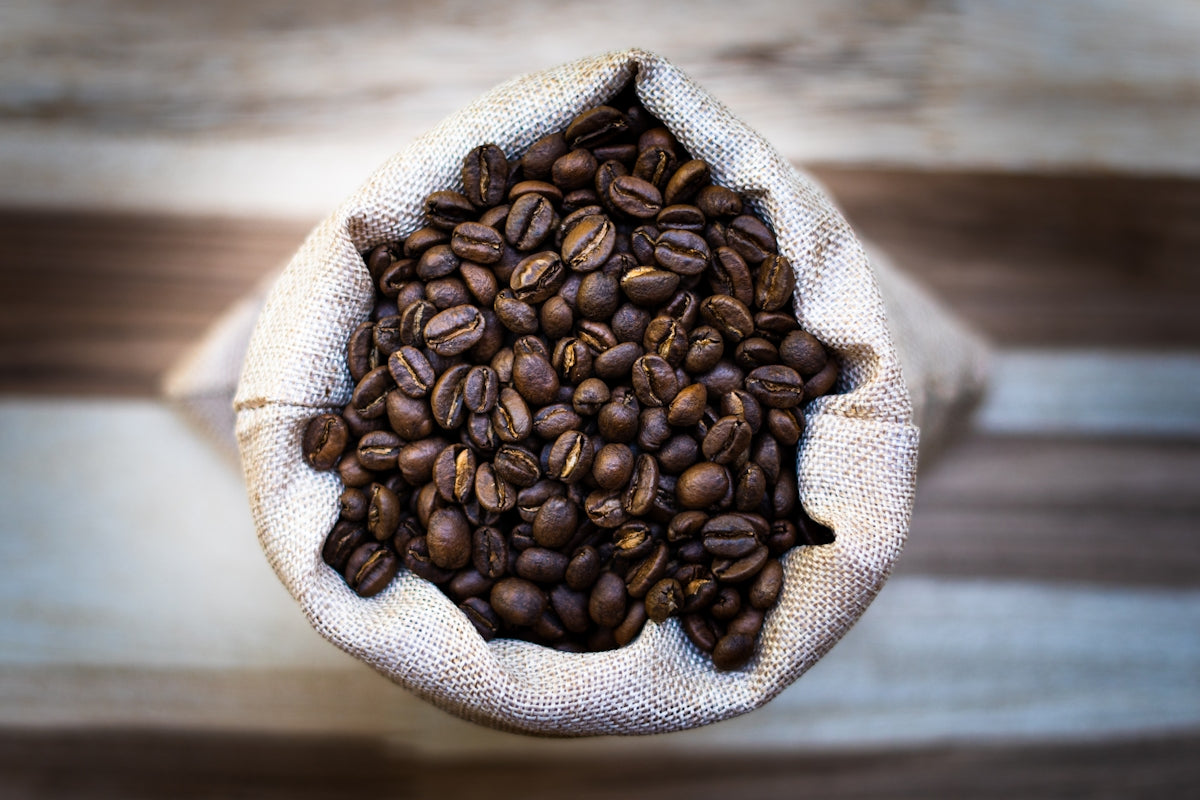 a bag of coffee beans on a wooden table