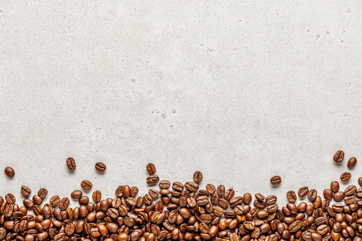 a group of coffee beans on a white surface