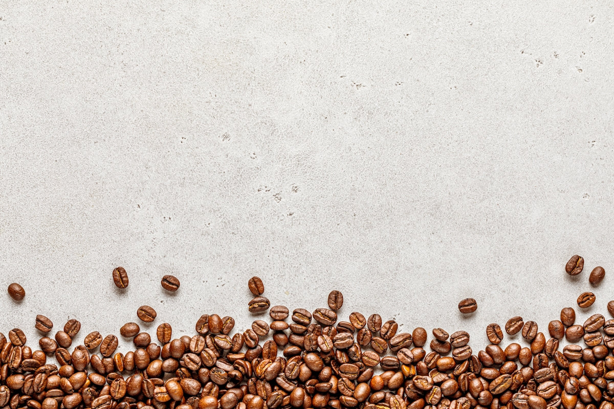 a group of coffee beans on a white surface