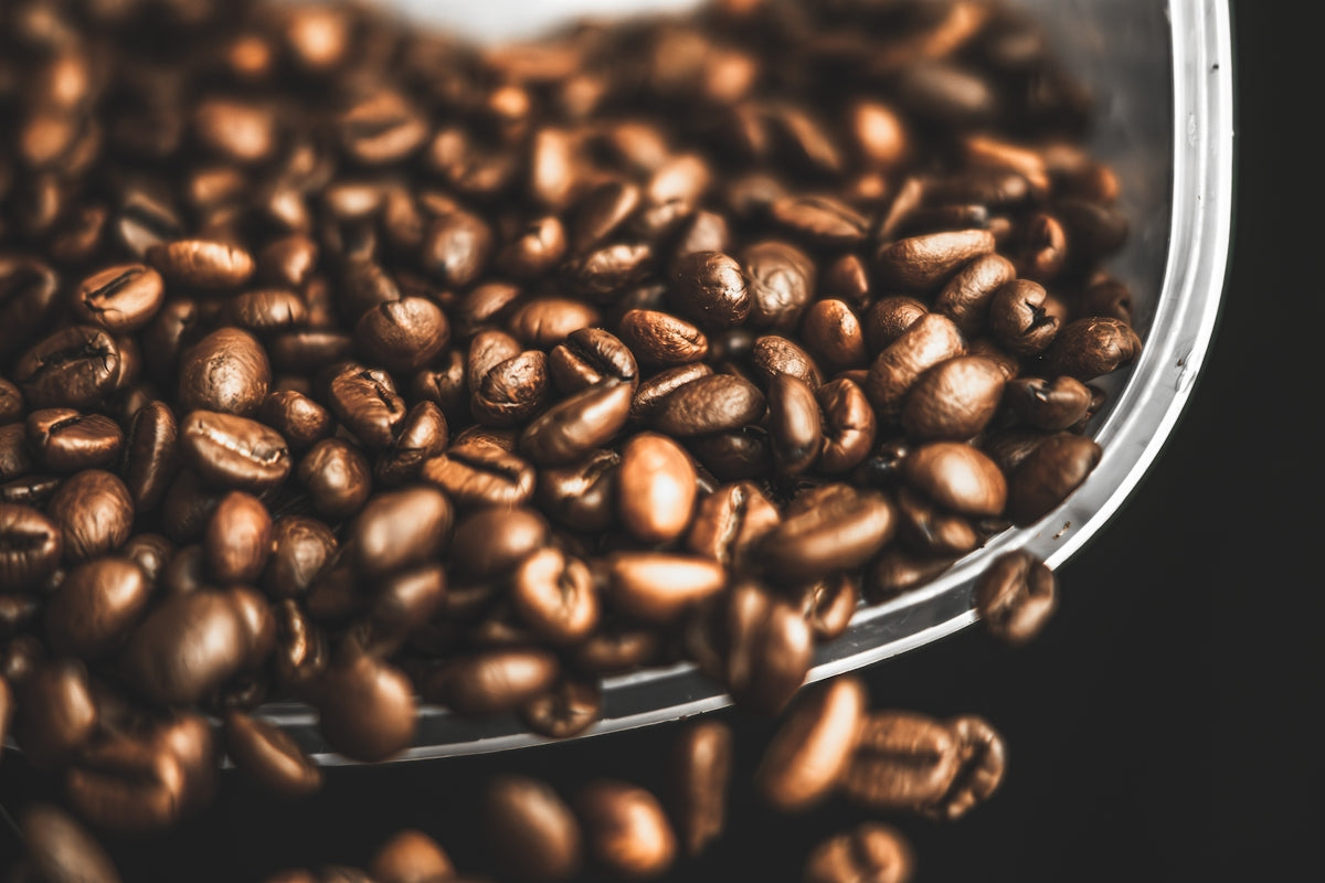 a close up of a bowl of coffee beans