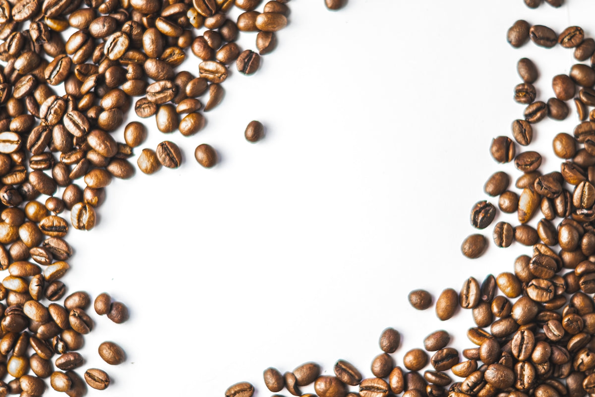 a pile of coffee beans on a white background