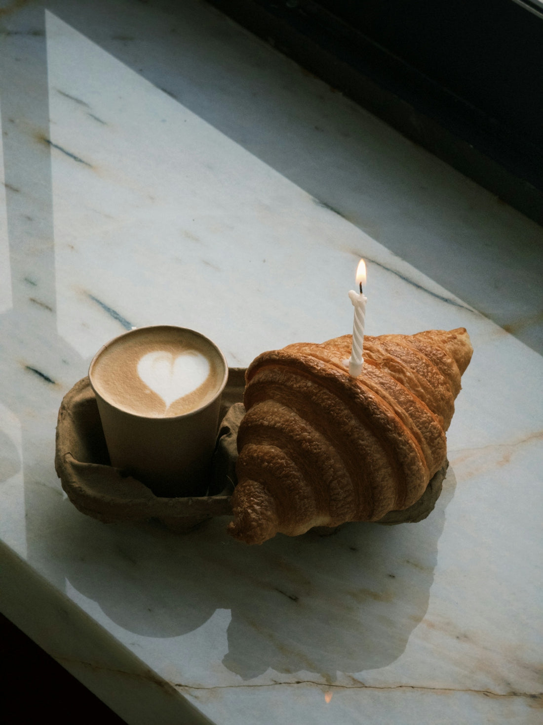 A cup of coffee with a heart on it