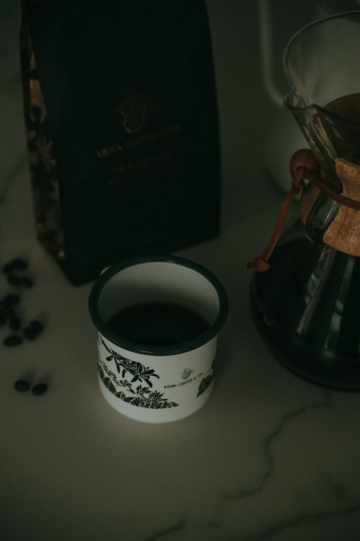 Coffee brewing setup with beans, cup, and carafe.